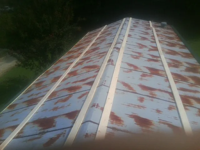 Rusted metal roof panels with new wood purlins before replacement — Storm Damage Roof Repair in Rodessa by Roofing Brothers