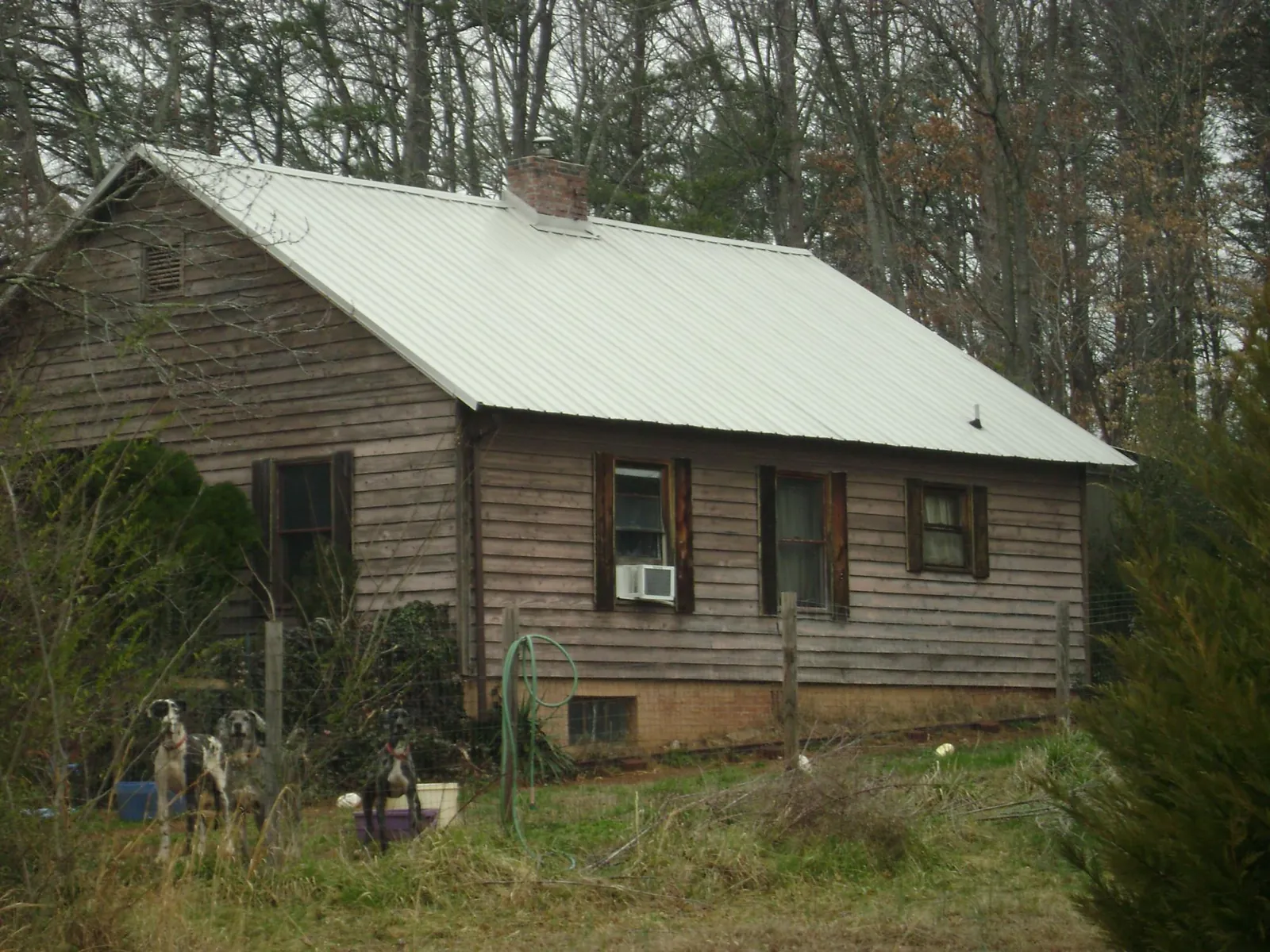 White metal roof on an old wood sided farmhouse, from a Asphalt Shingle Roof Repair job in Rodessa